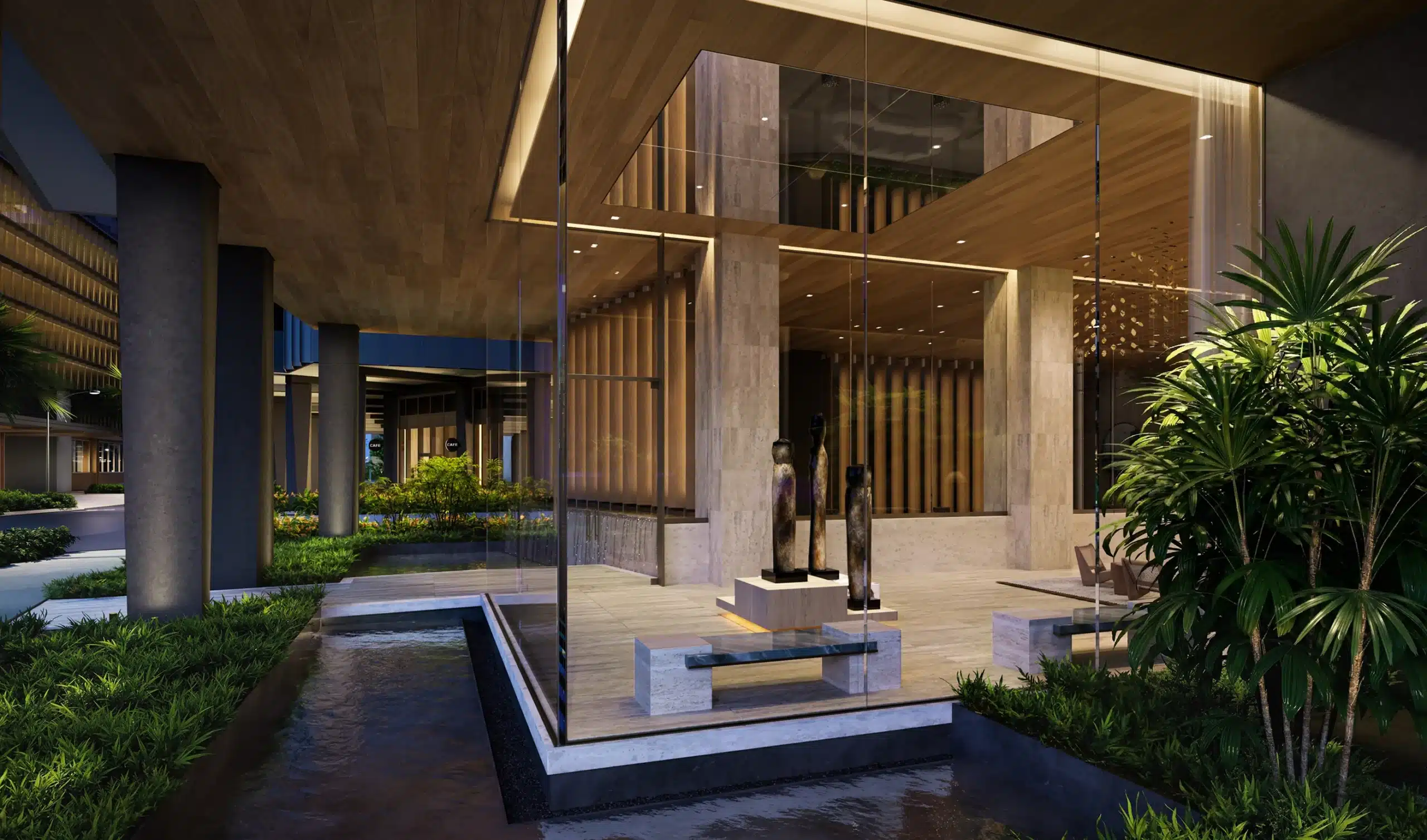 Modern hotel lobby with large glass walls, wood and stone accents, benches, sculptures, lush plants, and water features, illuminated by warm lighting at night.