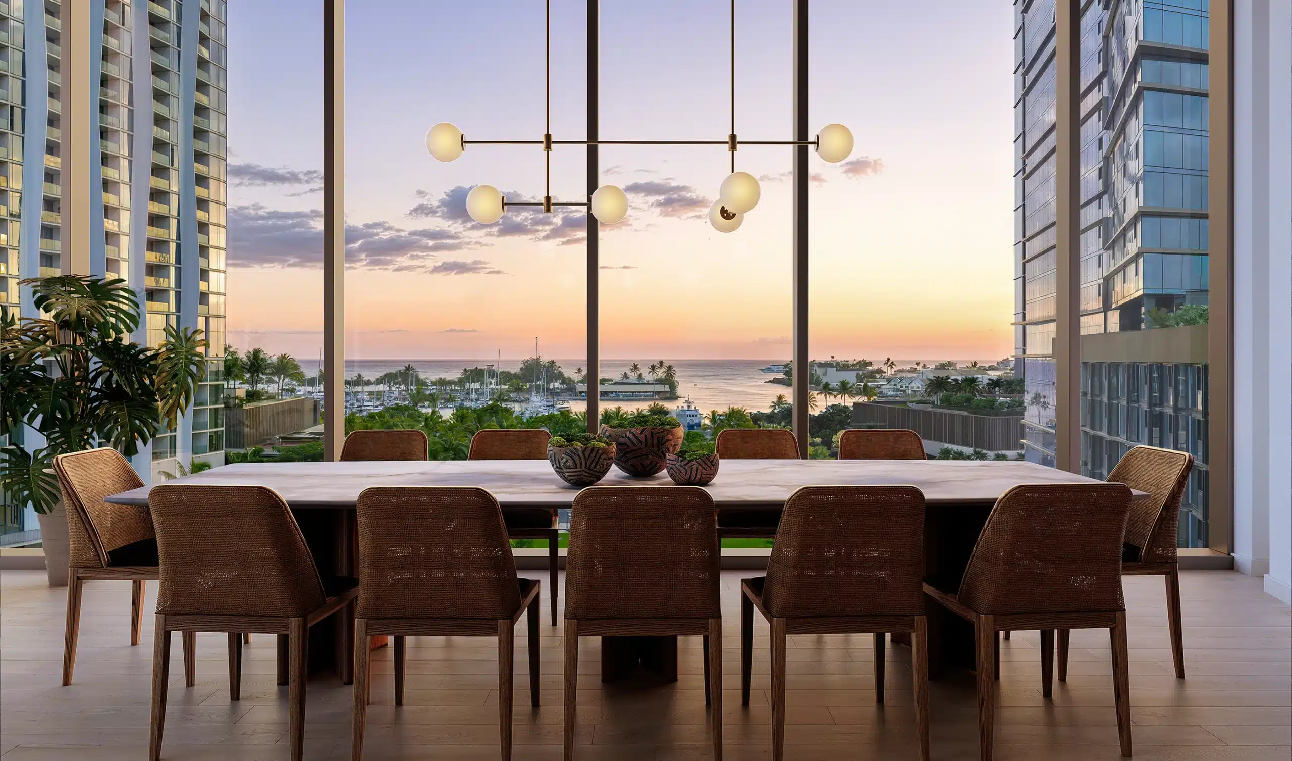 Modern dining room with eight chairs and a wooden table, large windows overlooking a marina and sunset, framed by tall buildings, contemporary chandelier overhead.
