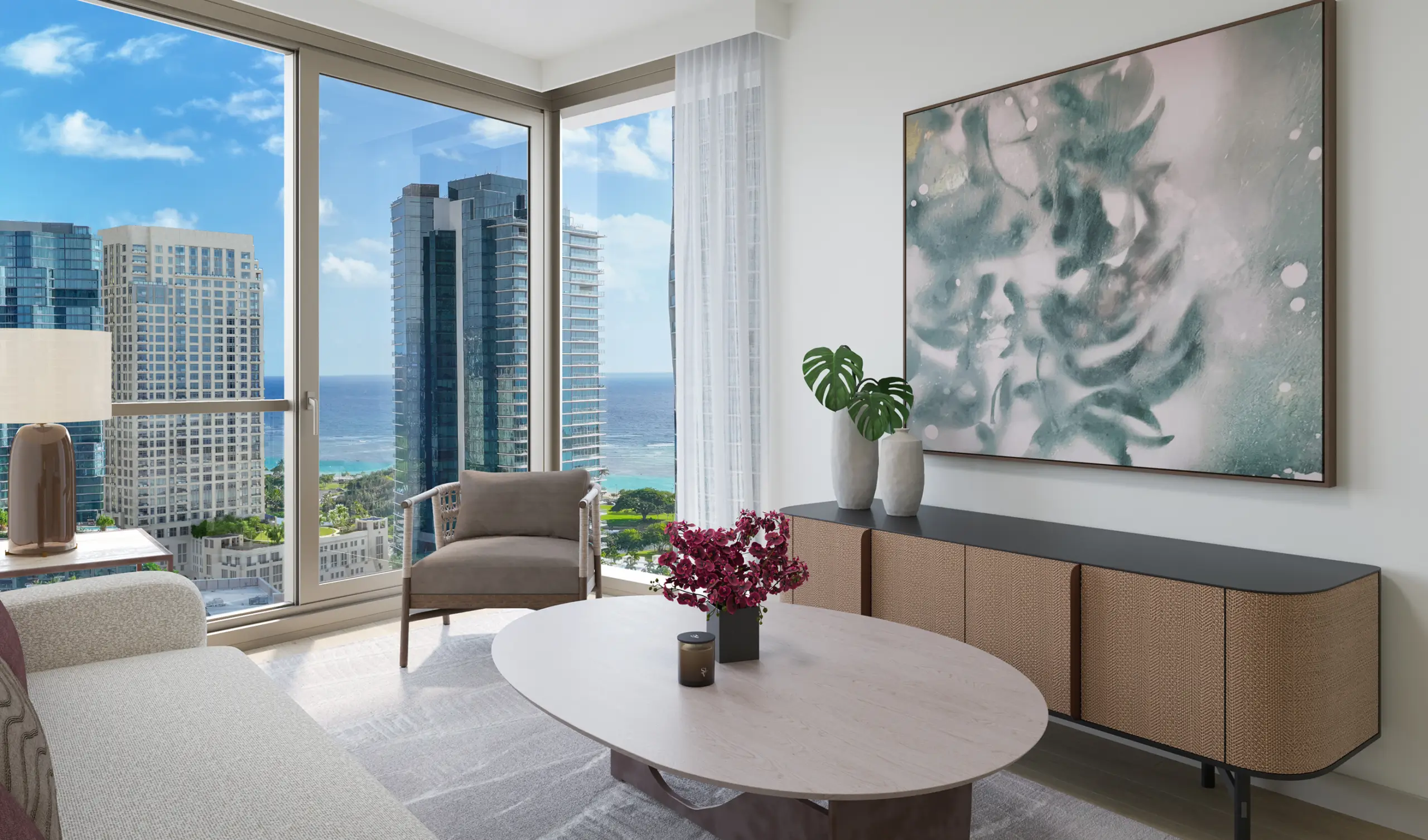 Modern living room with large windows, ocean and city view, neutral furniture, oval coffee table with purple flowers, and abstract artwork on the wall.