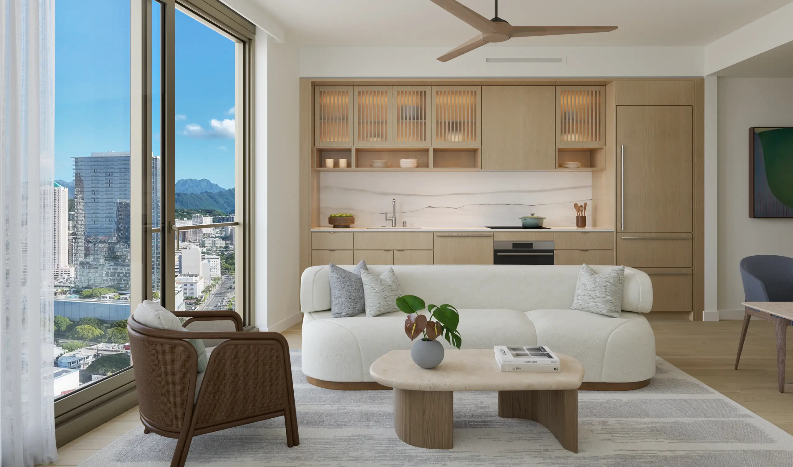 Modern living room with light wood cabinetry, a white sofa, a marble coffee table, and large windows showing a cityscape and mountains under a clear blue sky.