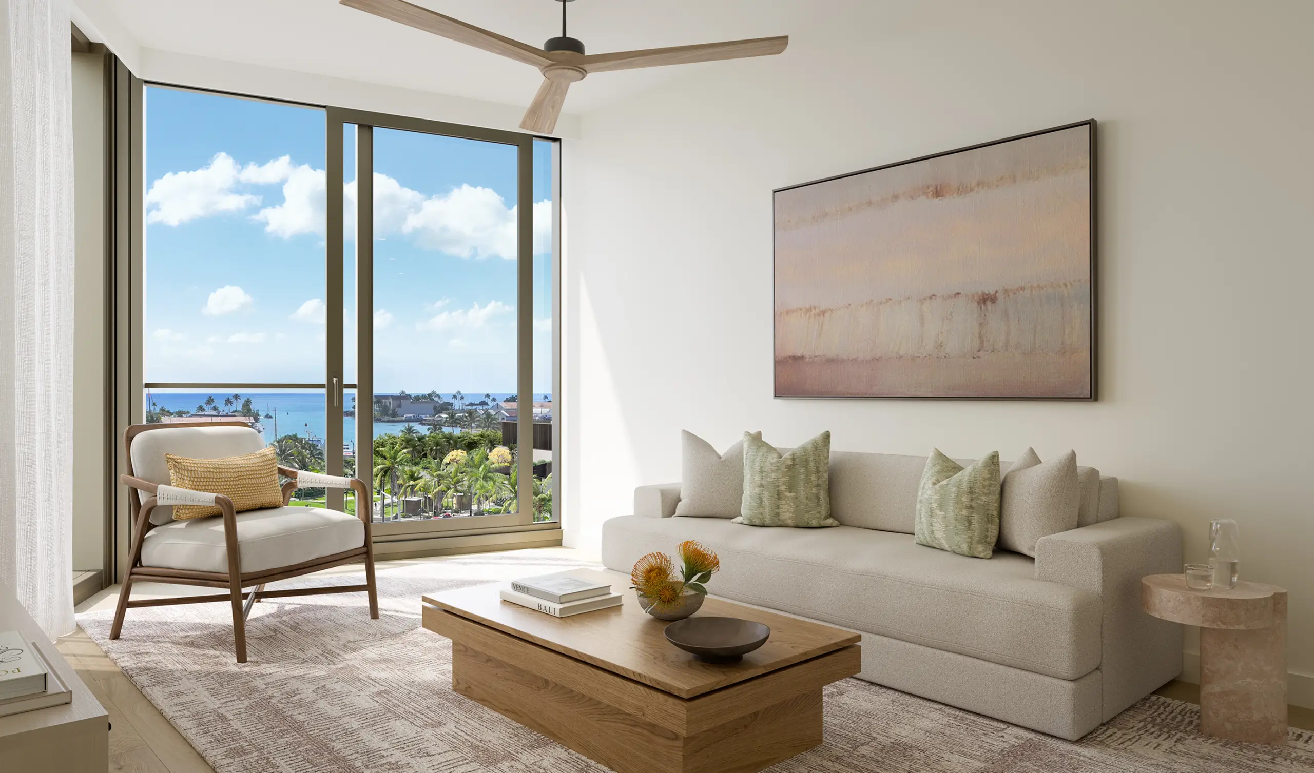 Modern living room with a beige sofa, armchair, coffee table, and large window showing a view of palm trees and the ocean under a blue sky with clouds.