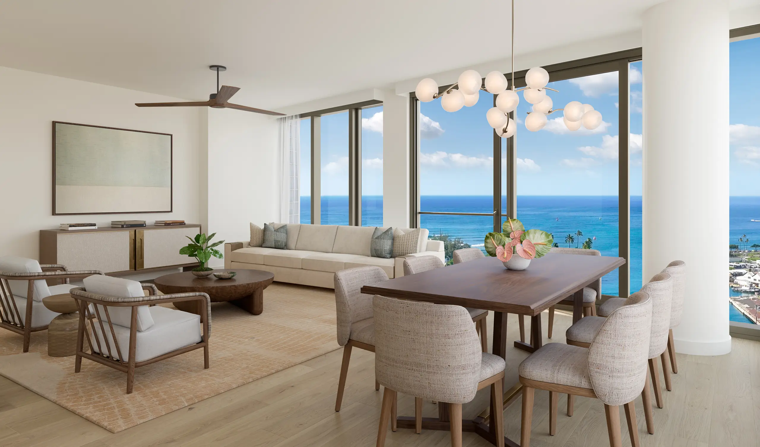 Modern living and dining area with large windows, ocean view, light wood floors, neutral furniture, a chandelier, and a potted plant on the dining table.